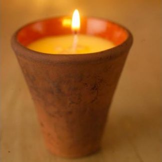 Small scented candle in terracotta pot