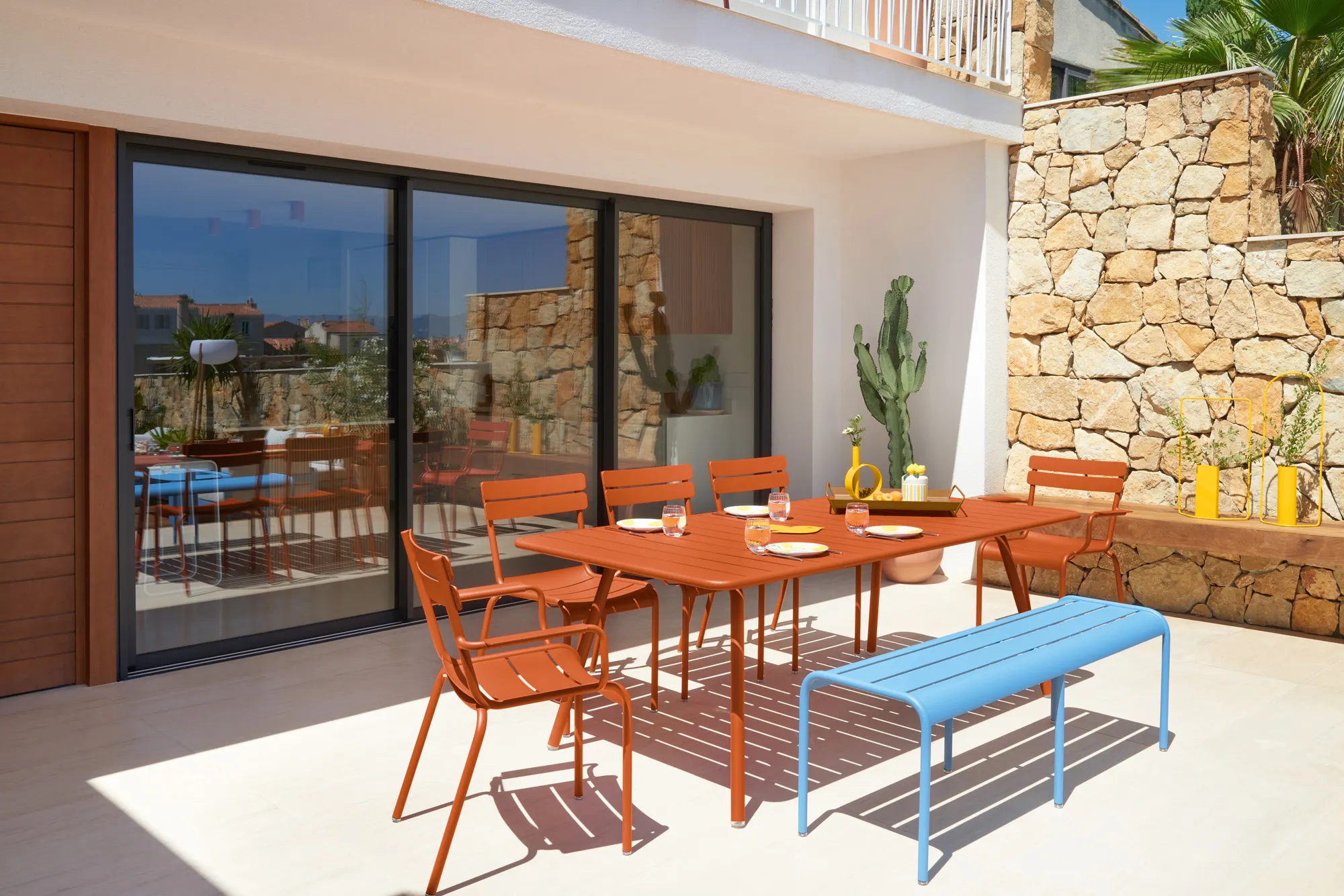 Luxembourg armchair, chairs table in Candied Orange (E2), Luxembourg bench in Maya Blue (E1)