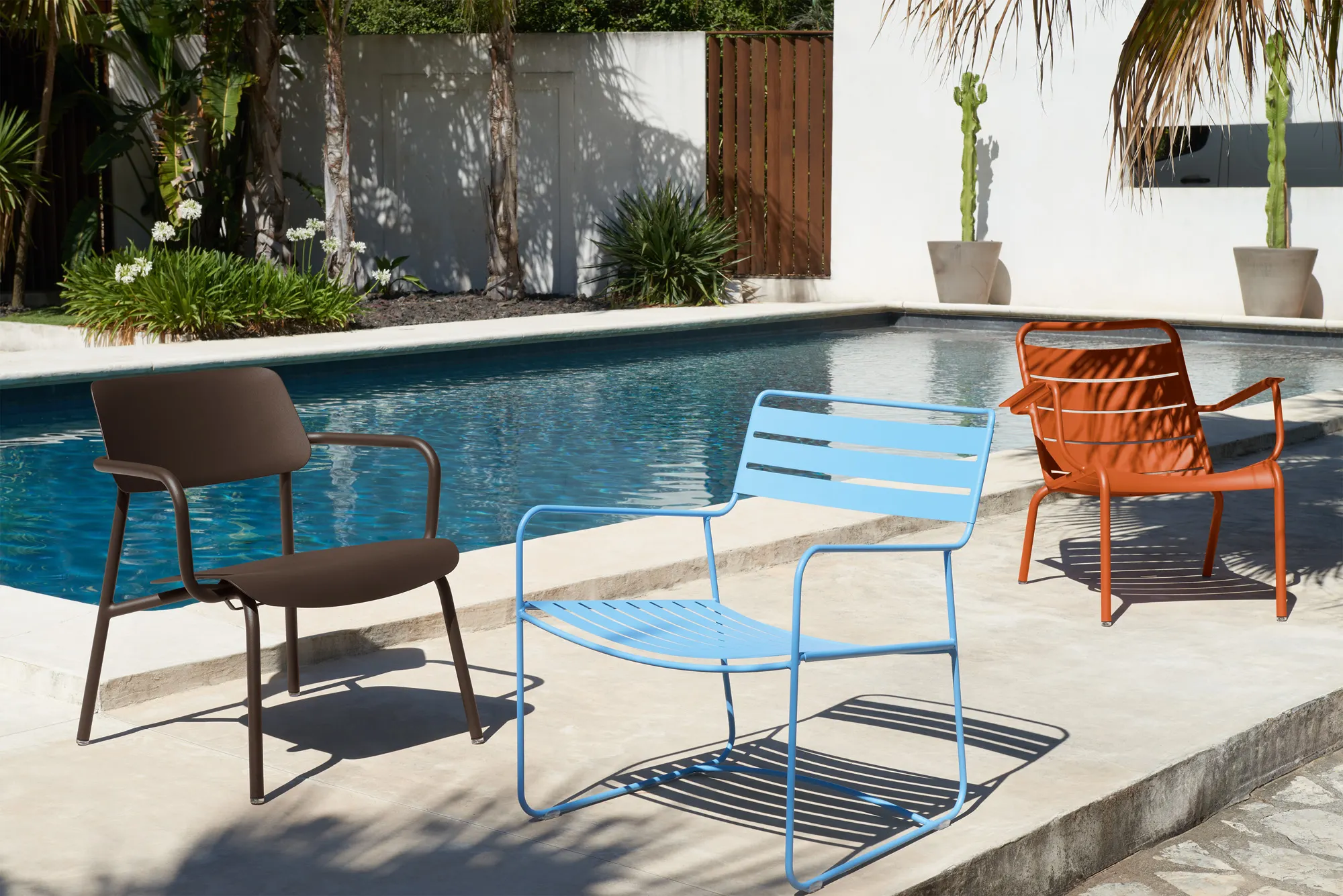 Surprising low armchair in Maya Blue (E1), Studie low armchair in Tonka (E3) and Luxembourg low armchair in Candied Orange (E2)